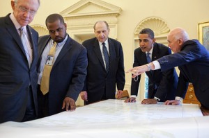 President Barack Obama meets with (from left) Senator Harry Reid, Joshua DuBois, Director of the White House Office for Faith-Based and Neighborhood Partnerships, Church President Thomas S. Monson and Elder Dallin H. Oaks in the Oval Office, July 20, 2009. During the meeting they looked at a five volume genealogy prepared by the Church's Family History Committee. Here they are examining a huge pedigree chart.